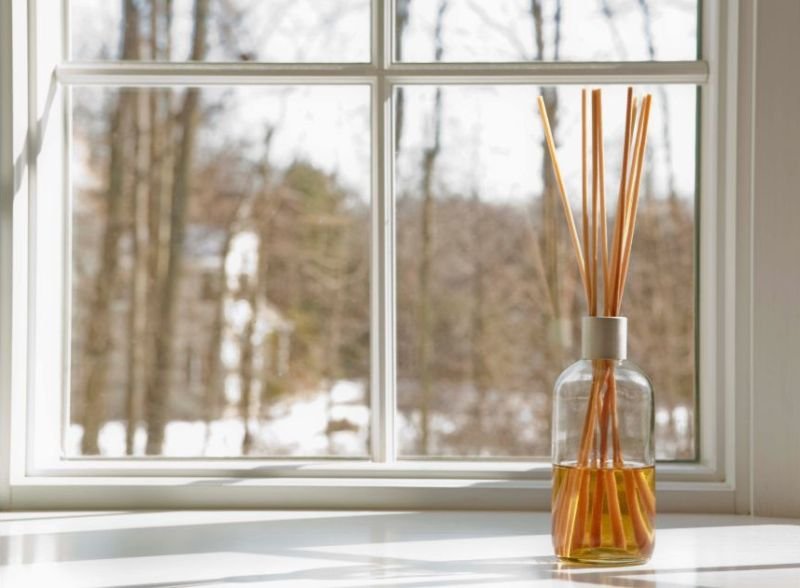 reed diffuser on a window sill