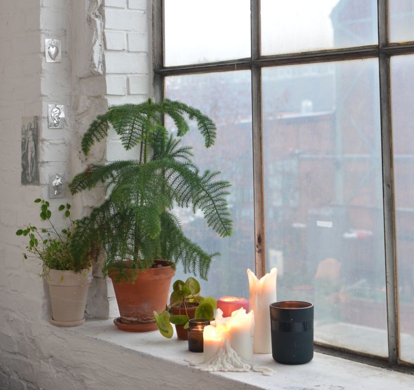 Candle placed on a wide window sill