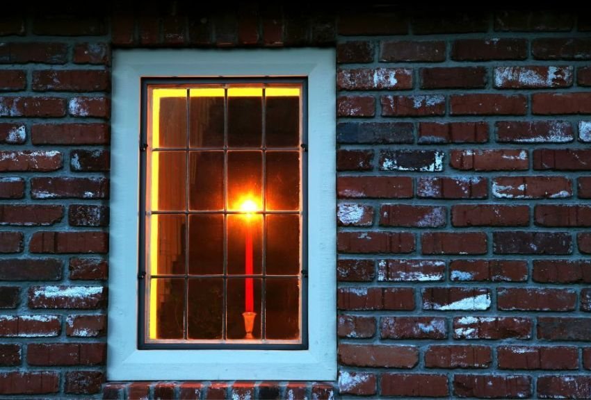 Why do people put a candle in the window - representation image shows a candle put in a window